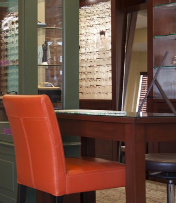 red chair at a desk in an optometry clinic