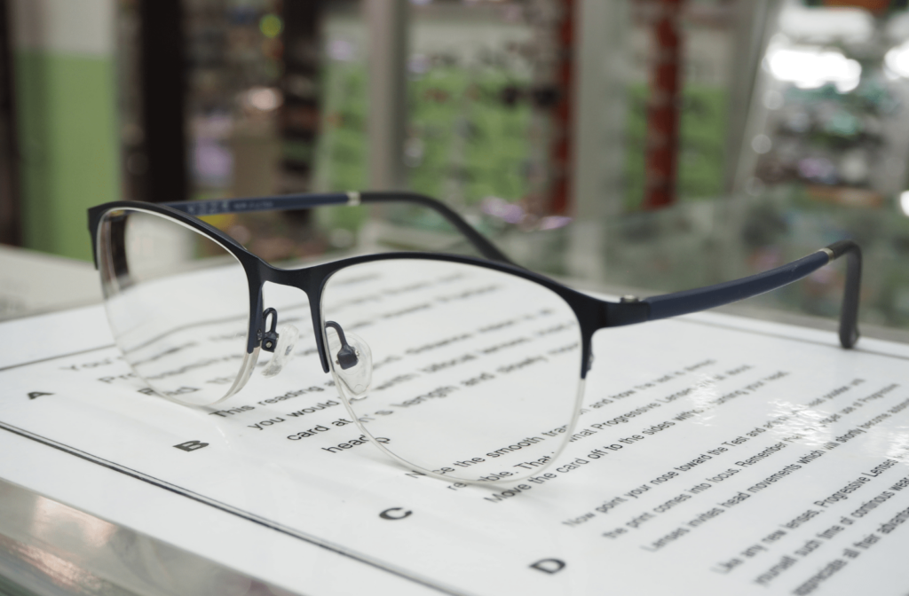 A pair of progressive lenses used as reading glasses, sitting on a book