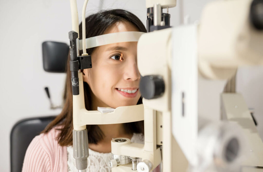 A woman is undergoing a retinal examination with a digital apparatus.