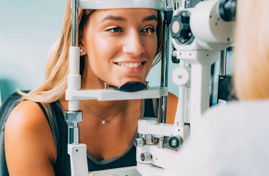 A woman is undergoing a retinal scan for an eye check-up at the eye clinic. An eye exam can detect early signs of heart disease in the eyes, such as an eye stroke, by scanning the retina.