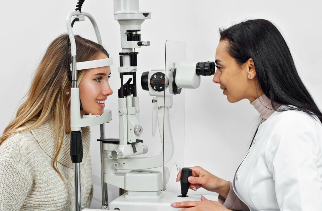 A woman receiving an eye exam from her female optometrist.