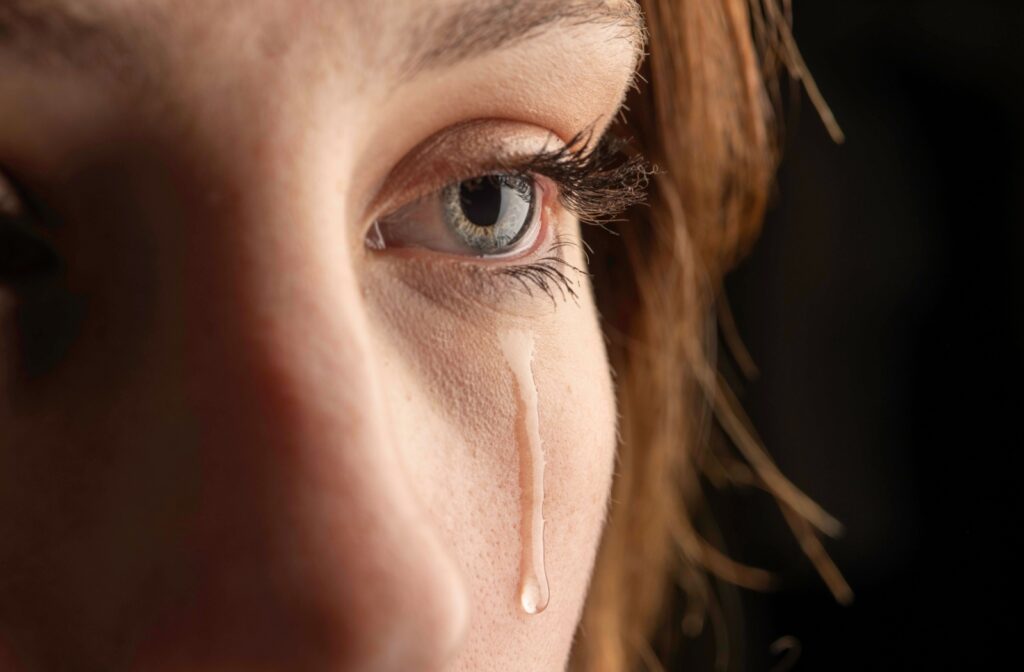 A close up of a tear streaming down a person's face.