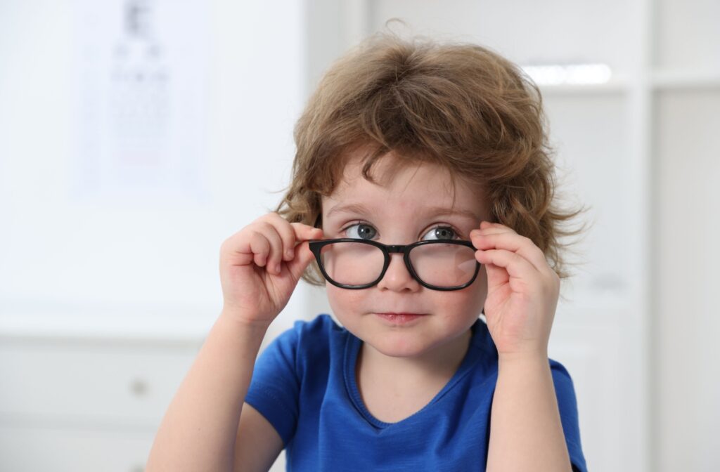 A young kid wearing glasses to correct myopia.