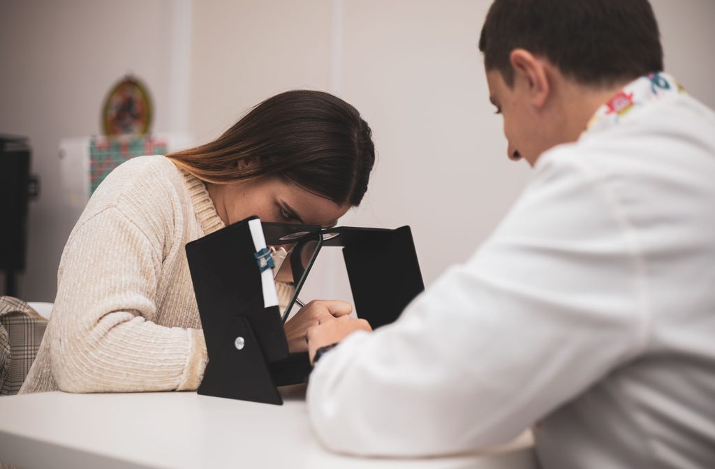 A patient at their optometrist's office going through a set of eye exercises for their vision health.